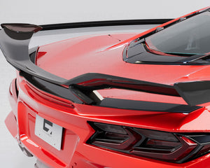 Rear view of a red Corvette C8 showcasing the wide rear bumper and spoiler wing.