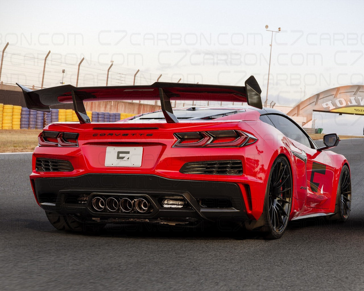 Rear view of a Corvette C8 Z06 ERAY ZR1 with carbon fiber spoiler, parked on a race track