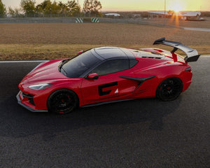 Top view of Corvette C8 Z06 ERAY ZR1 with carbon fiber spoiler at sunset on race track