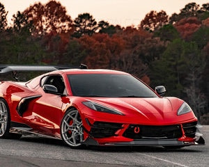 Corvette C8 Legacy Edition with carbon fiber front splitter on a track.