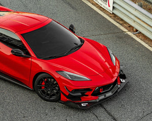 Top view of a red Corvette C8 Legacy Edition with front splitter on a racetrack.