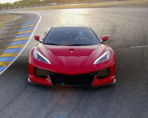 Front view of Corvette C8 with C8R Style Wide Body Kit on track during sunset