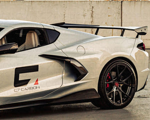 Driver side view of C8 Corvette with OEM style carbon fiber high wing spoiler installed