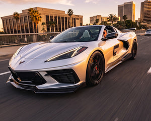 Front three quarter driving shot of silver C8 Corvette Stingray with 5VM style carbon fiber side rockers