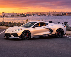 Front three quarter sunset profile of silver C8 Corvette Z51 with carbon fiber Race Edition wing