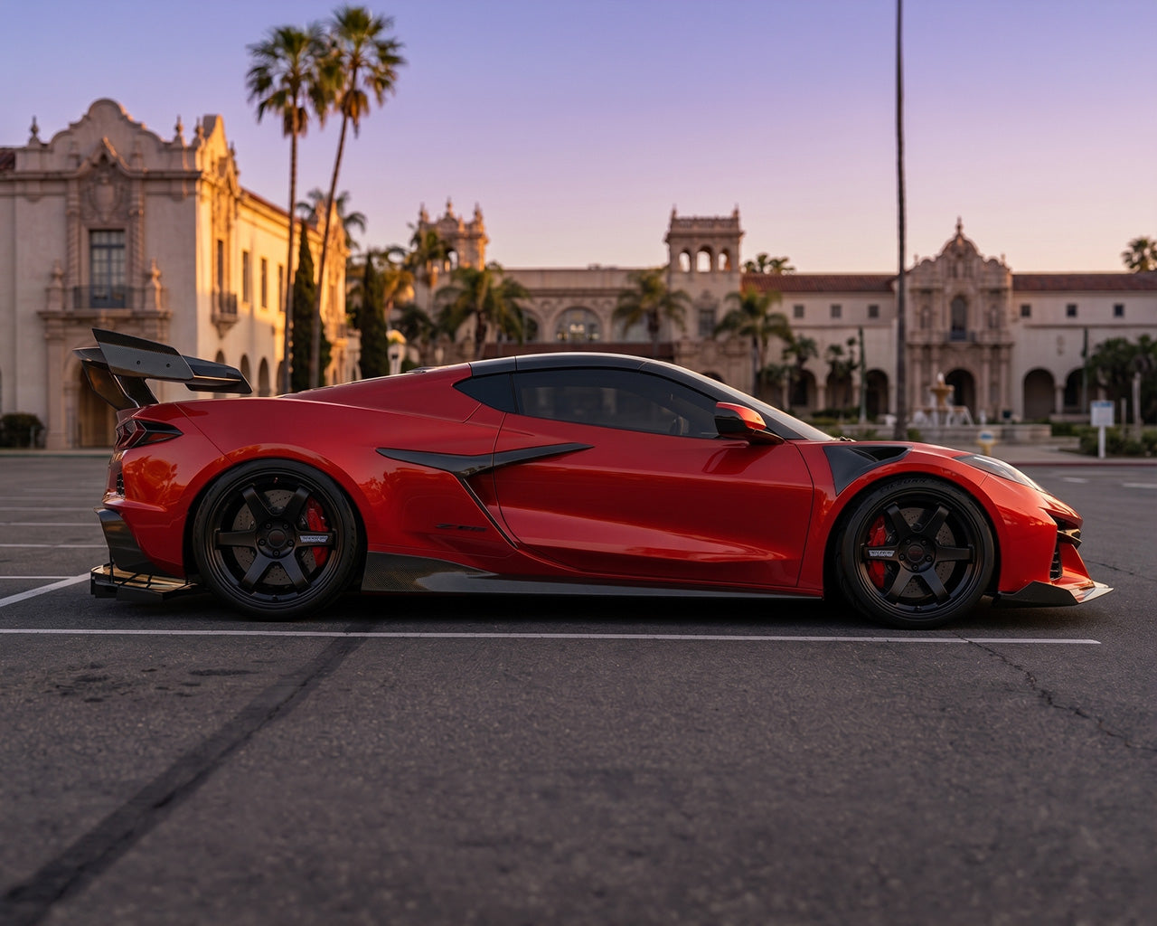 Full side profile stance of red C8 Corvette Z06 featuring low-drag Legacy Edition carbon rocker panel extensions