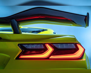 Close up view of carbon fiber upright and high wing mounted on yellow C8 Z06 taillight area
