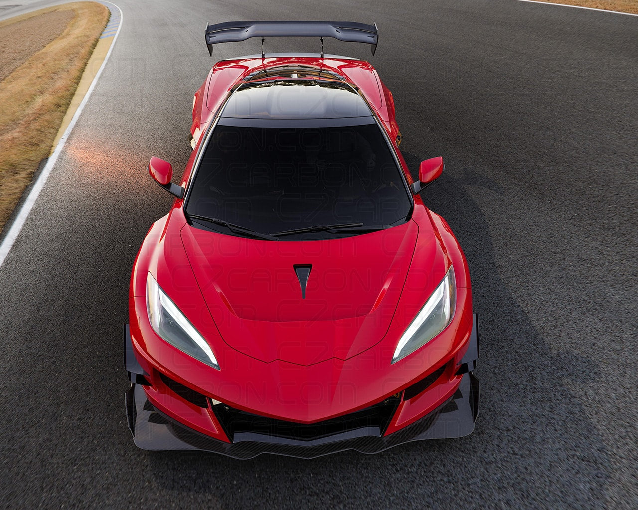 Front view of Corvette C8 GT3 widebody kit on a racetrack, highlighting the aerodynamic features and aggressive styling.
