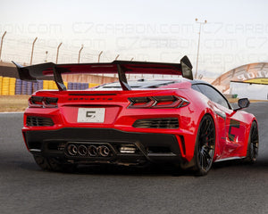 Rear view of a Corvette C8 Z06 ERAY ZR1 with carbon fiber spoiler, parked on a race track