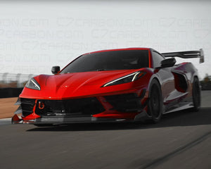 Red Corvette C8 Legacy Edition driving on a racetrack with its side profile visible.