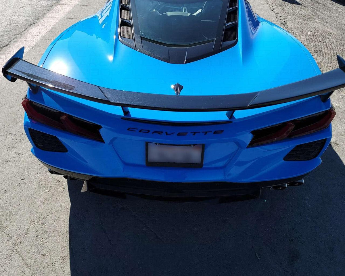 Direct rear view of blue C8 Corvette Stingray with carbon fiber OEM style high wing spoiler
