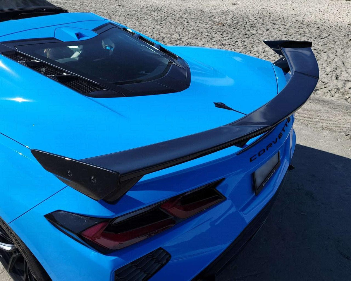 Overhead rear decklid view of blue C8 Corvette with OEM style carbon fiber high wing