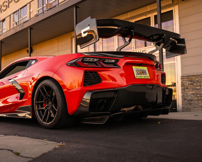 Low rear decklid view of red C8 Corvette showing CNC chassis mounted upright brackets and Victory wing