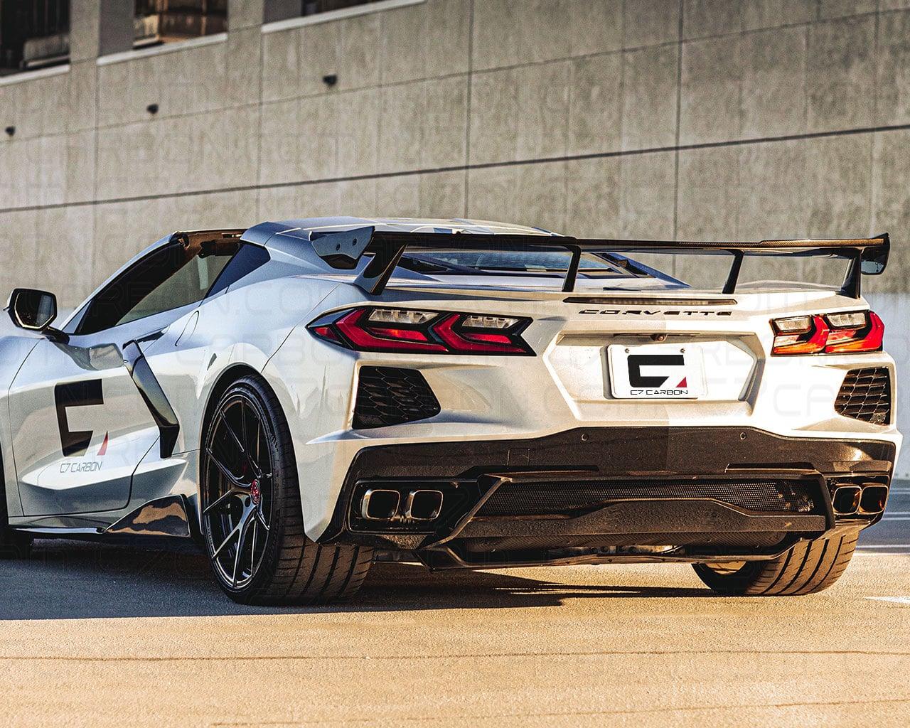 Silver C8 Corvette Stingray featuring carbon fiber OEM style high wing spoiler