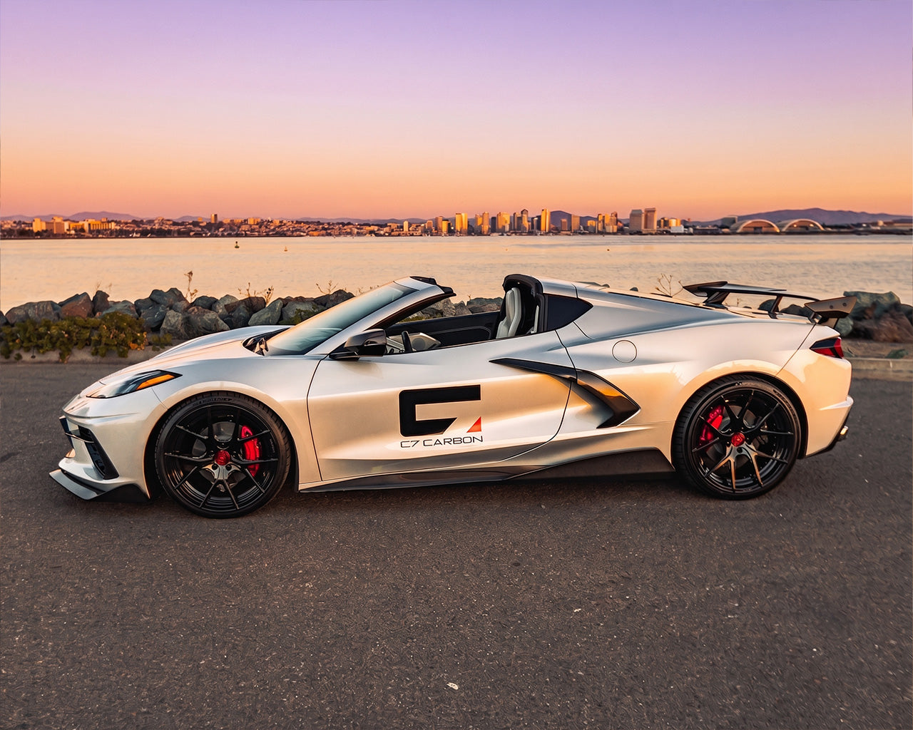 Full side profile of silver C8 Corvette convertible showing 5VM carbon fiber side skirt rocker panels