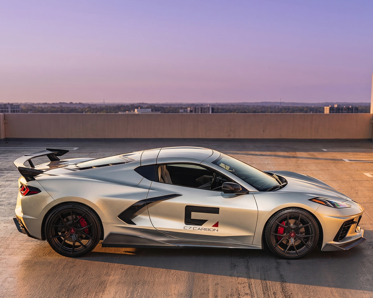 Low side angle view of silver C8 Corvette Stingray featuring extended rocker panel side skirts