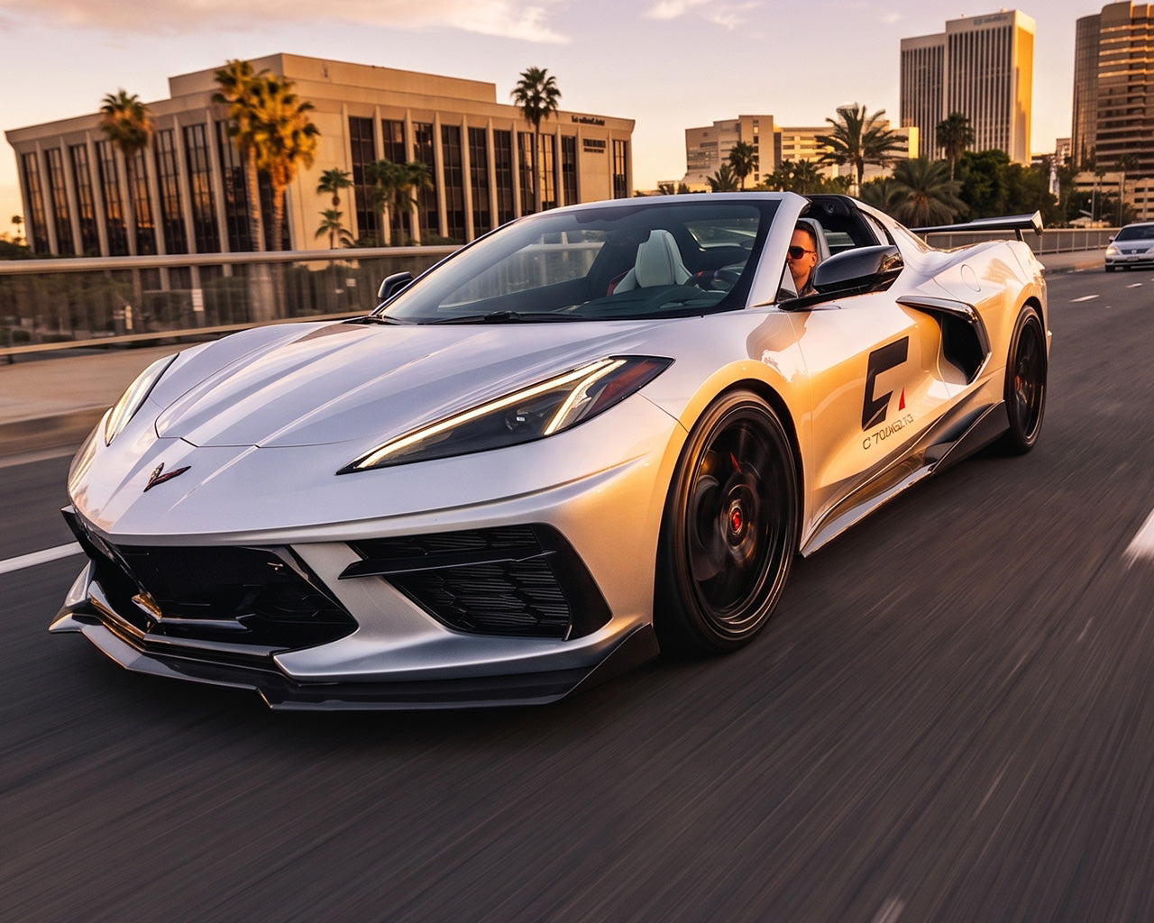 Front three quarter driving shot of silver C8 Corvette Stingray with 5VM style carbon fiber side rockers