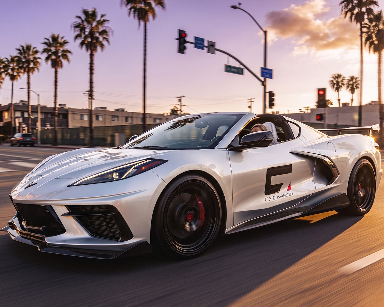 Silver C8 Corvette Stingray driving with 5VM style carbon fiber side skirts and underbody extensions