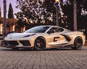 Parked front three quarter stance of silver C8 Corvette coupe with 5VM carbon fiber aerodynamic aero package