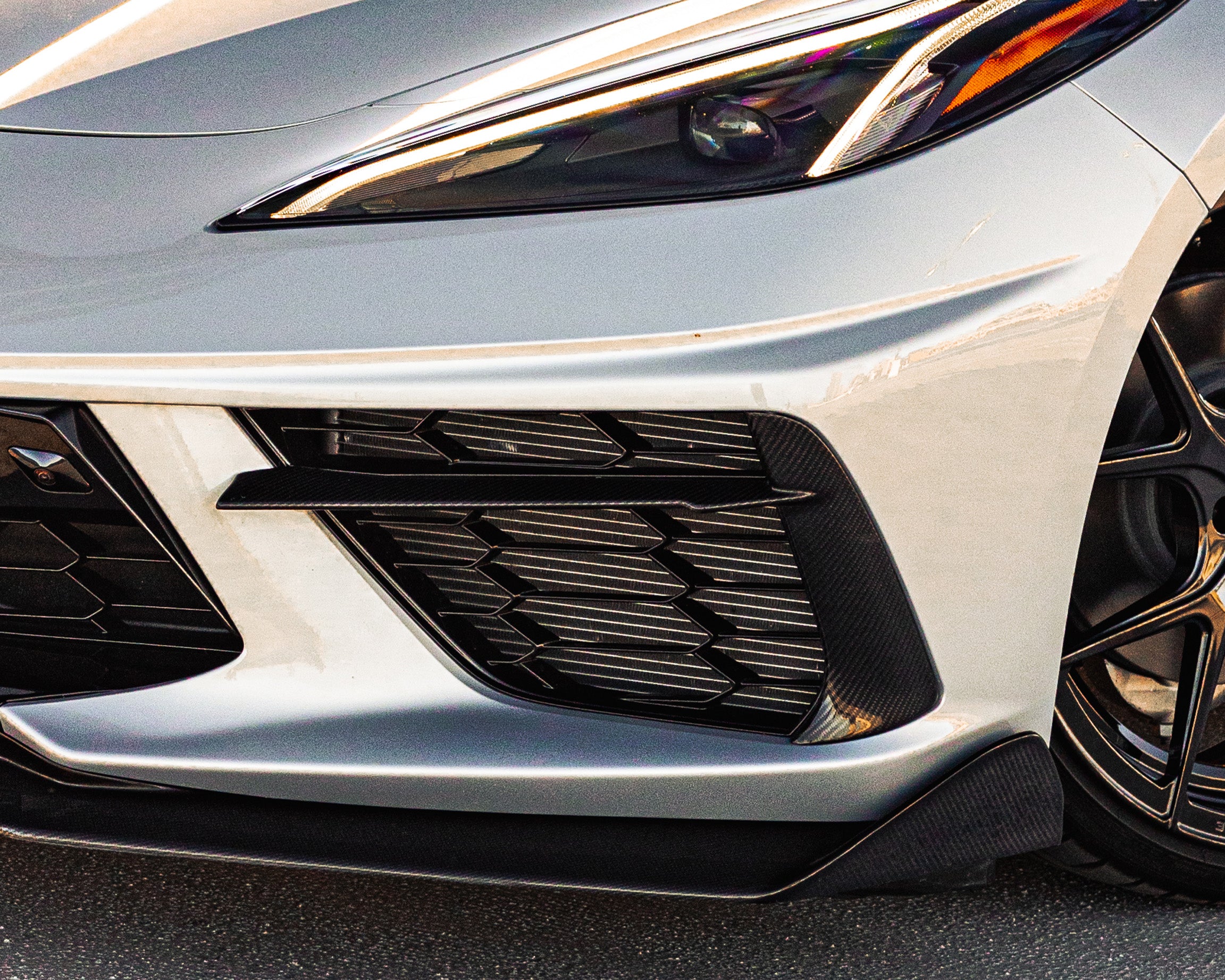 C8 Corvette front bumper carbon fiber grille bezels installed on silver Stingray