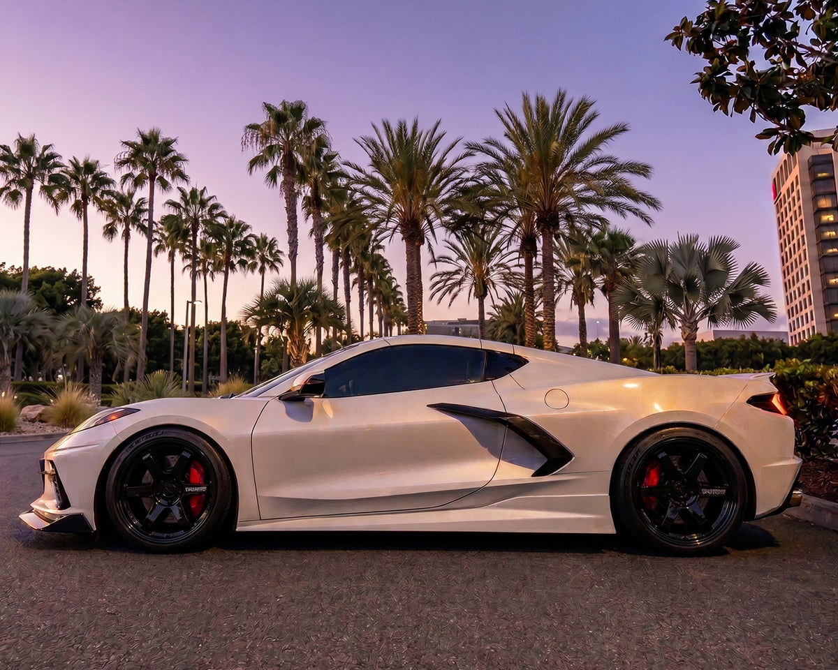 Side profile angle of white C8 Corvette Stingray with flush-mount carbon fiber Legacy side skirts