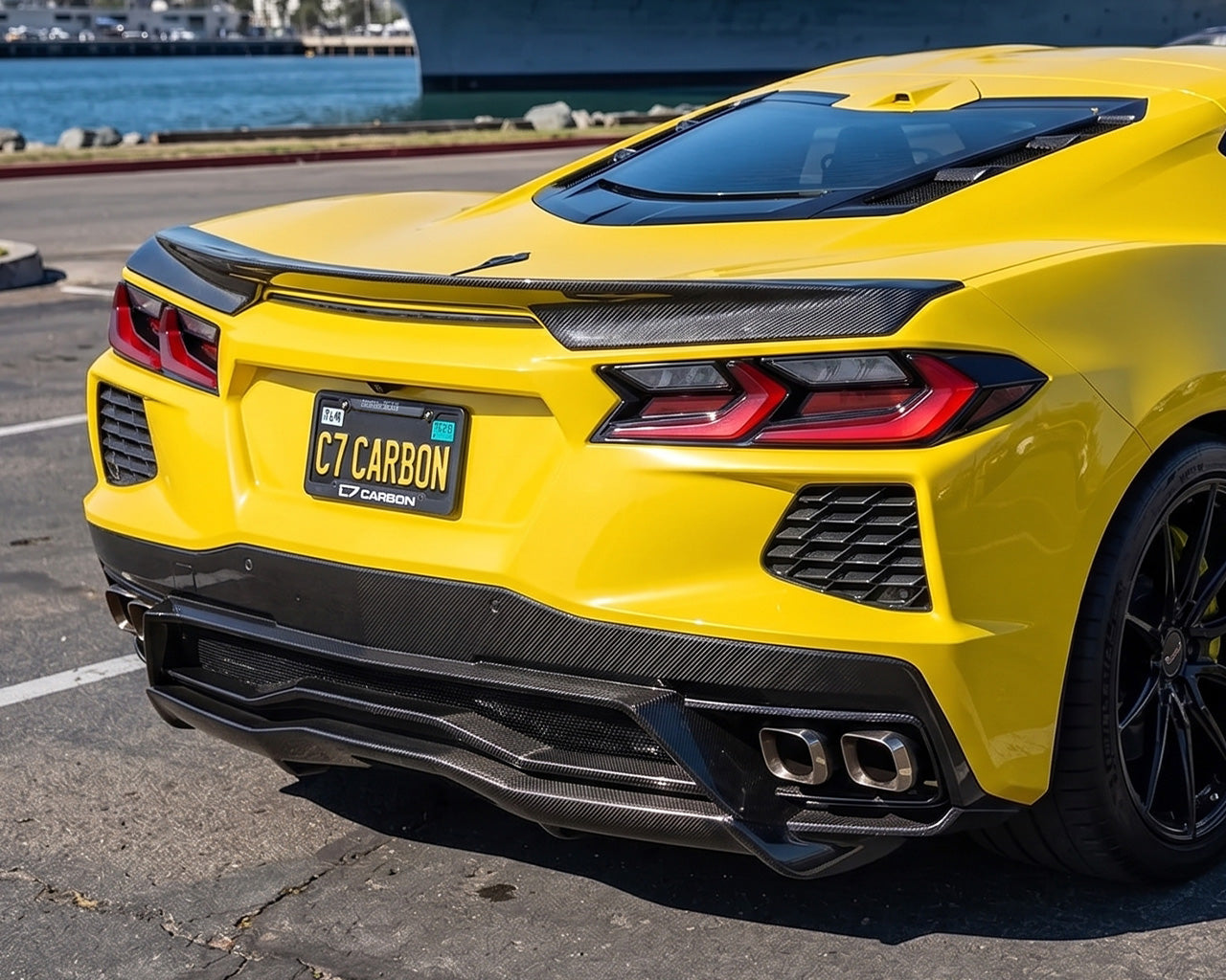 Rear decklid view of pre-preg carbon fiber low profile spoiler on yellow C8 Corvette