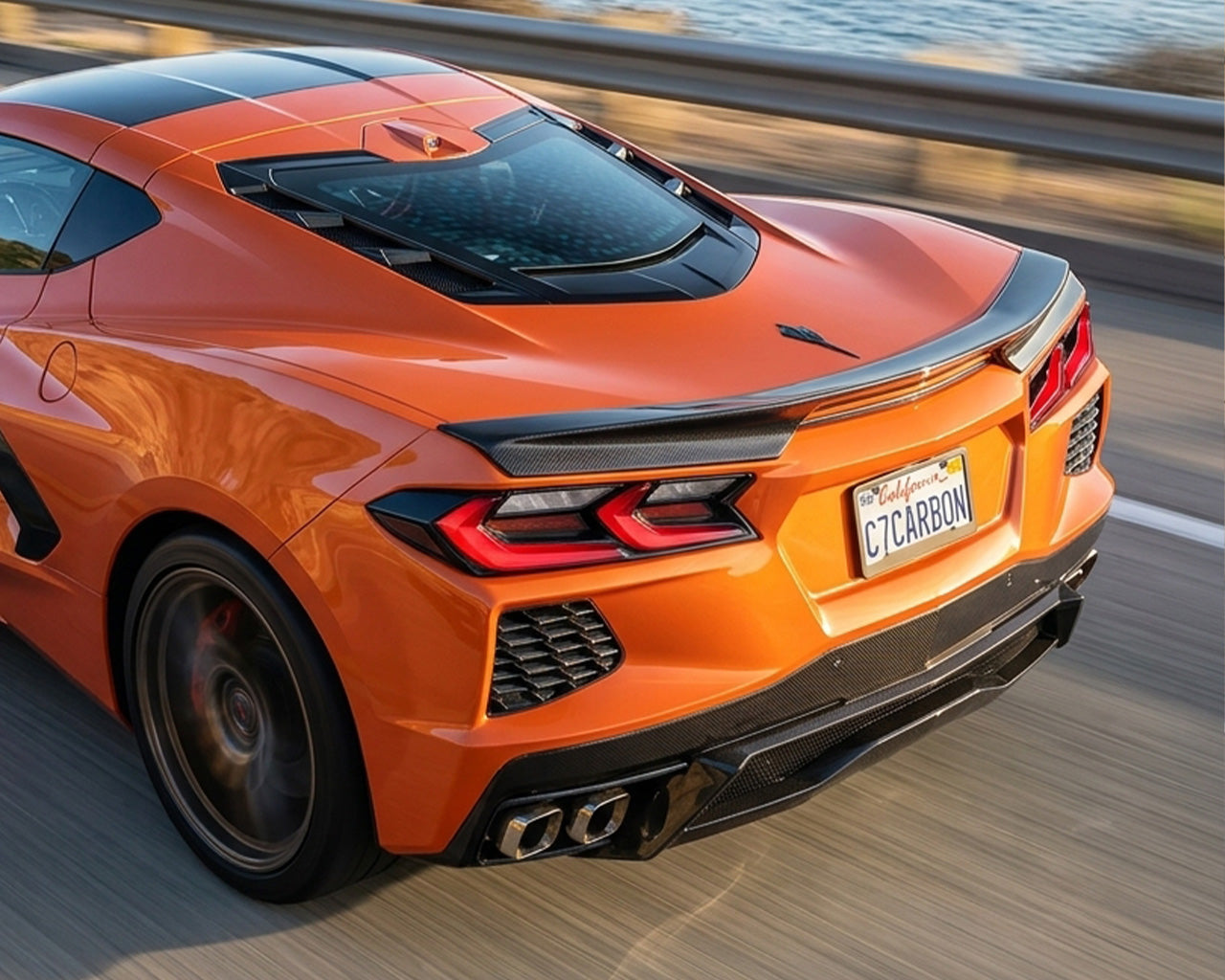 Orange C8 Corvette Stingray driving with carbon fiber low profile rear spoiler installed