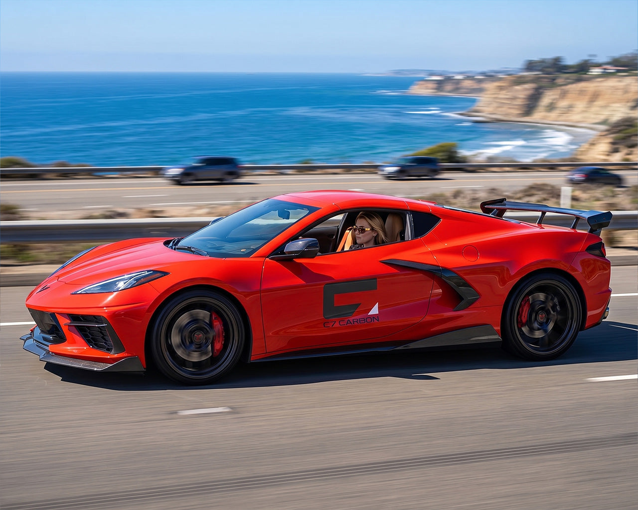 Red C8 Corvette Stingray parked along ocean with OEM style 5VM performance high wing