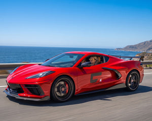 Side profile stance of red C8 Corvette Z51 equipped with performance high wing spoiler