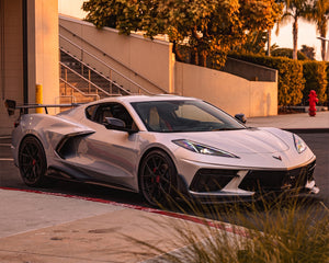 Front three quarter view of white C8 Corvette Stingray equipped with carbon fiber aero and race wing