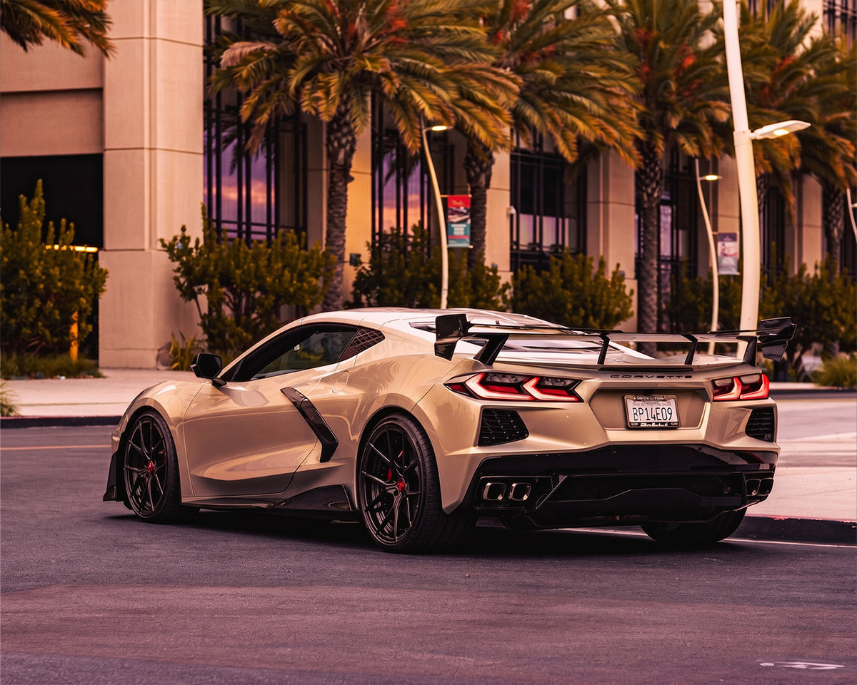 Rear quarter angle of white C8 Corvette coupe showing aggressive Race Edition carbon high wing spoiler