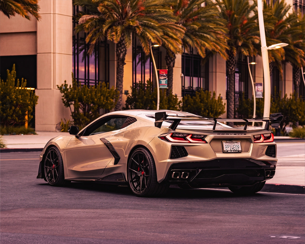 Rear quarter angle of white C8 Corvette coupe showing aggressive Race Edition carbon high wing spoiler