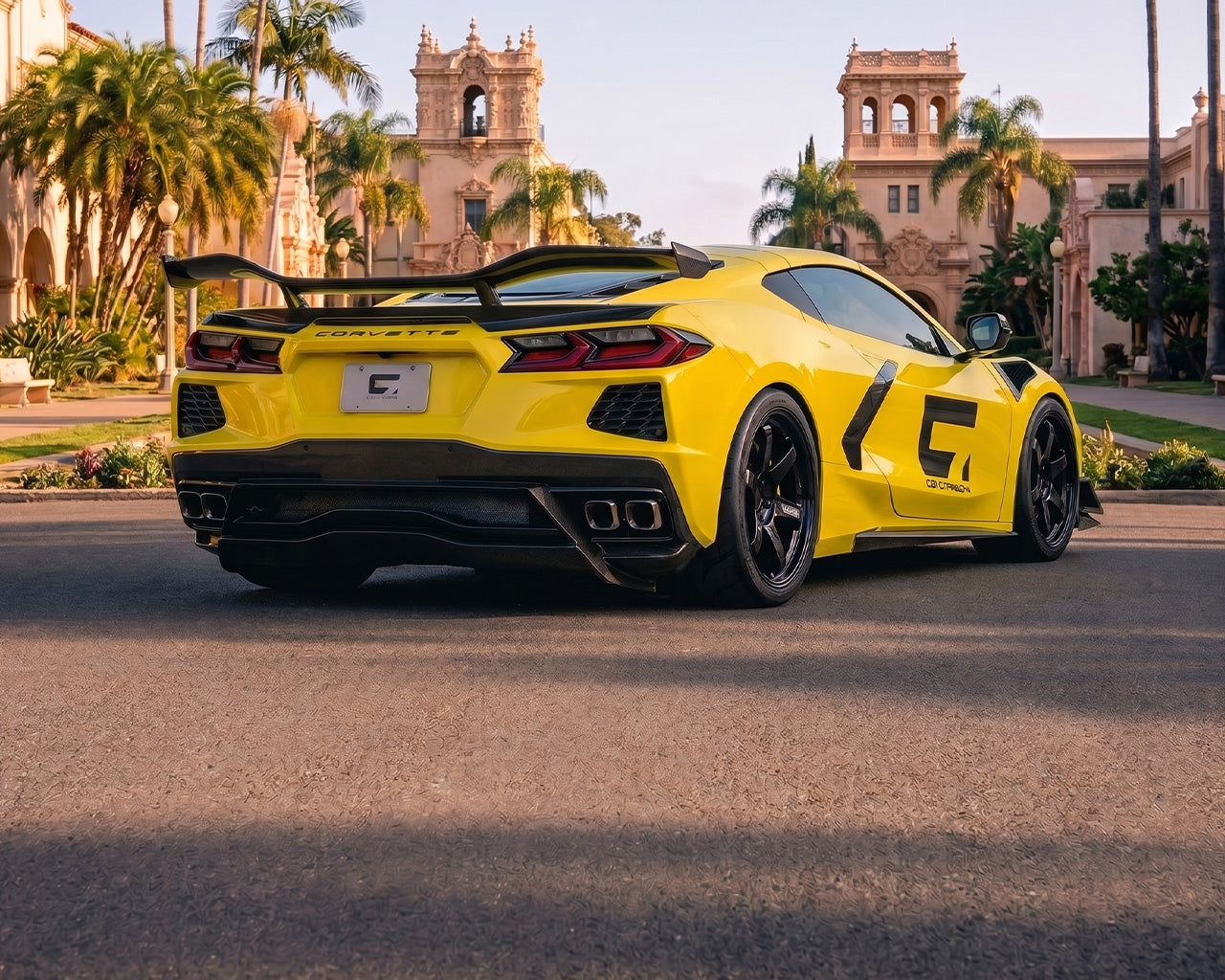 Low direct rear stance of yellow C8 Corvette Stingray showing chassis upright brackets and integrated decklid ducktail