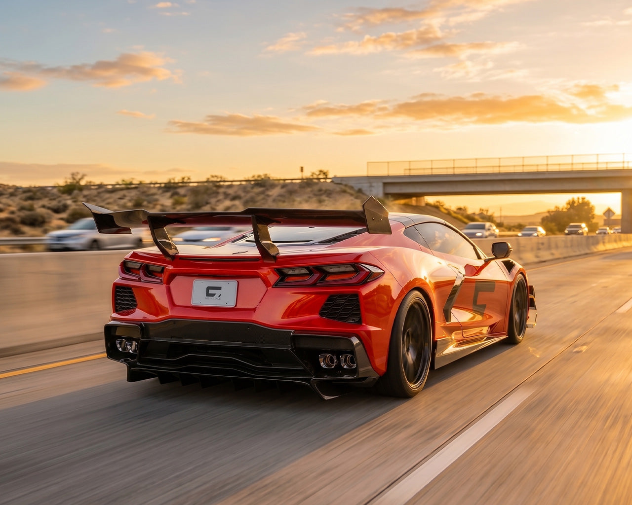 C8 Corvette Stingray driving on highway with ZR1 style carbon fiber high wing spoiler installed