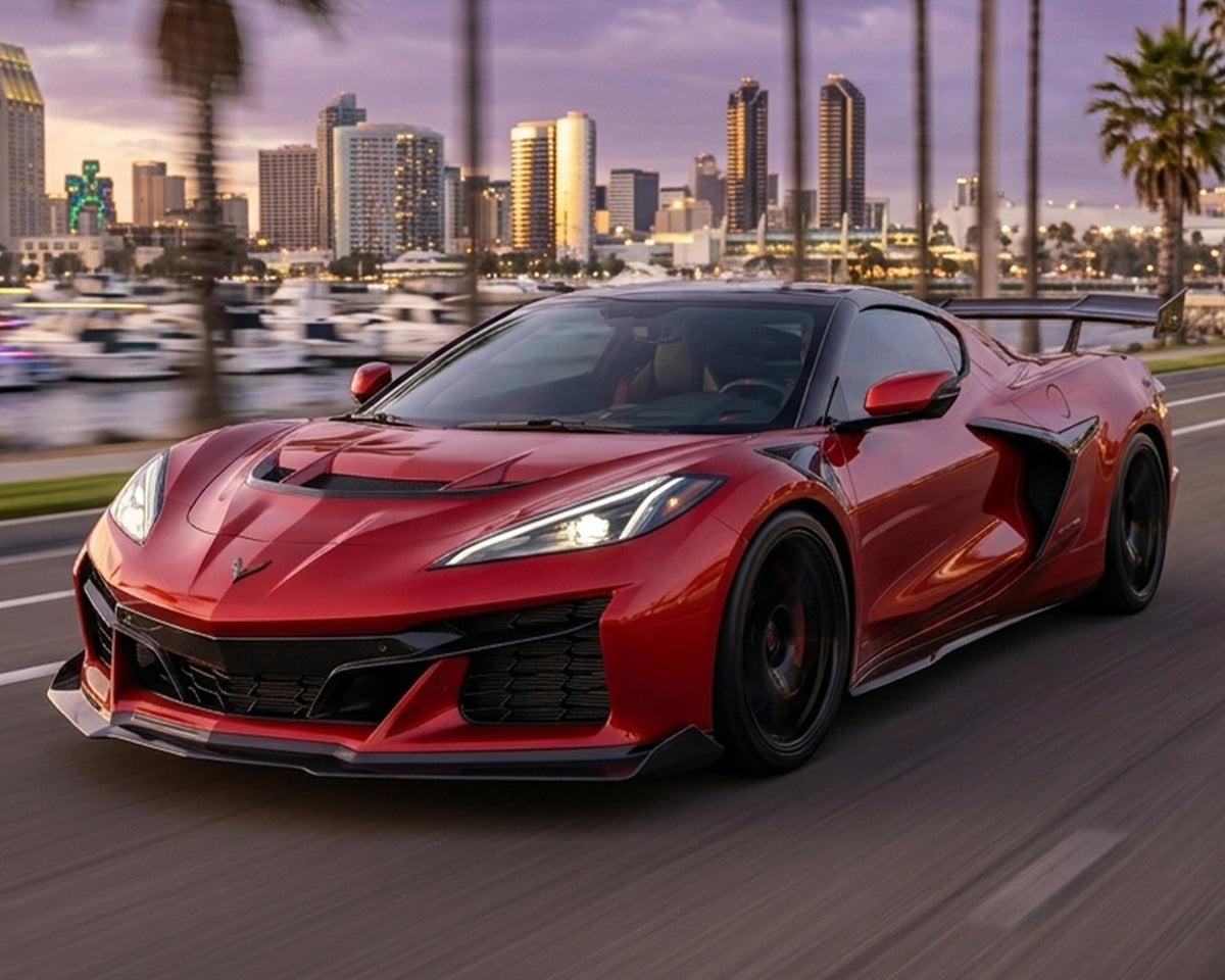 Front three quarter action shot of red C8 Corvette Z06 showing extended carbon fiber rocker panel extensions