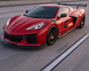 High angle driving view of widebody Corvette C8 Z06 E-Ray with aerodynamic carbon side splitters