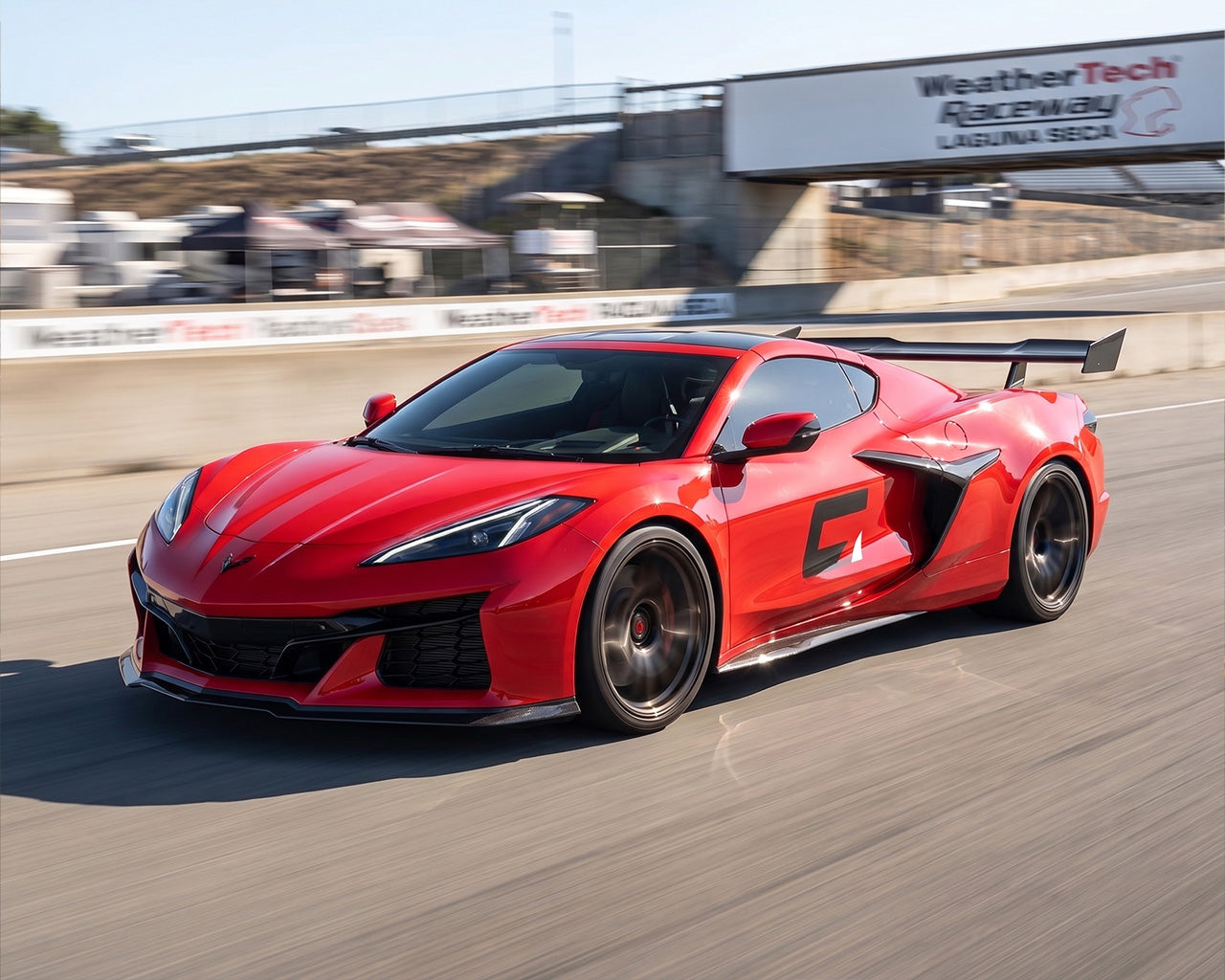 Front three quarter view of red C8 Corvette Z06 equipped with carbon fiber aerodynamic high wing