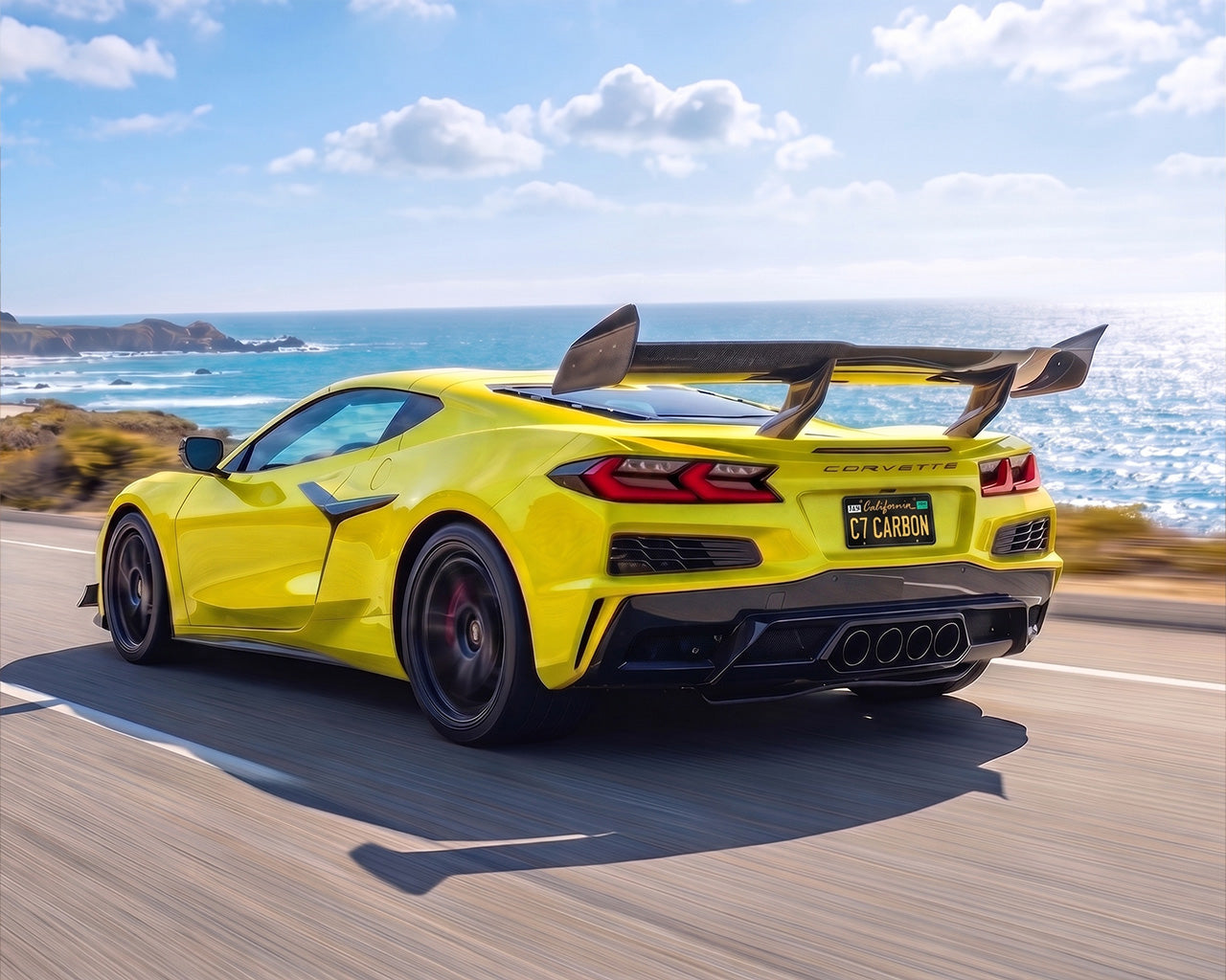 Yellow widebody C8 Corvette Z06 driving along coast with carbon fiber ZR1 high wing spoiler