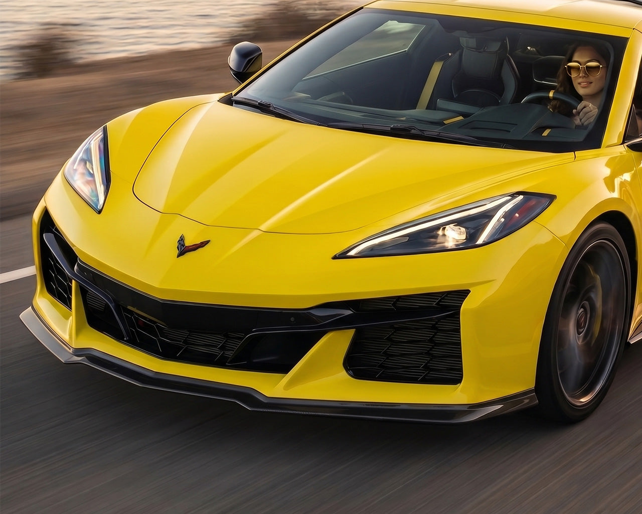 C8 Corvette Z06 Z07-style 3-piece front splitter lip installed on yellow Corvette driving